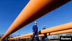 FILE - Engineers oversee the gas distribution system in Kiskundorozsma, 170 kilometers south of Budapest, through which Hungary's FGSZ Gas distribution company routes Russian gas toward Serbia, Jan. 15, 2015.