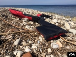 A life jacket discarded on the beach as refugees and other migrants are still arriving by the hundreds daily, according to people inside the refugee camp in Lesbos, Greece, April 1, 2016. (H. Murdock/VOA)