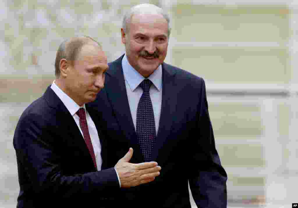 Belarus President Alexander Lukashenko, right, welcomes Russian President Vladimir Putin, in Minsk, Belarus, Feb. 11, 2015. 