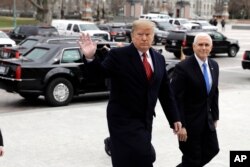 President Donald Trump arrives with Vice President Mike Pence to attend a Senate Republican policy lunch on Capitol Hill in Washington.