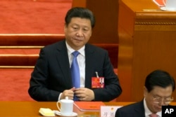 Chinese President Xi Jinping attends the closing session of the annual National People's Congress in Beijing's Great Hall of the People, March 16, 2016.