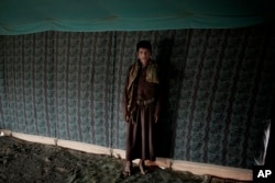 Nawaf, a 15-year-old former child soldier, poses for a photograph at a camp for displaced persons where he took shelter with his family, in Marib, Yemen, in this July 27, 2018, photo. (AP Photo/Nariman El-Mofty)