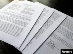 FILE - US Attorney General William Barr's signature is seen on a four-page letter to U.S. congressional leaders on the conclusions of Special Counsel Robert Mueller's report on Russian 2016 election meddling after the letter was released by the House Judi
