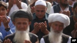 Afghan Muslims attend Eid al-Adha prayers in Kabul, Afghanistan, Sunday, Aug. 11, 2019