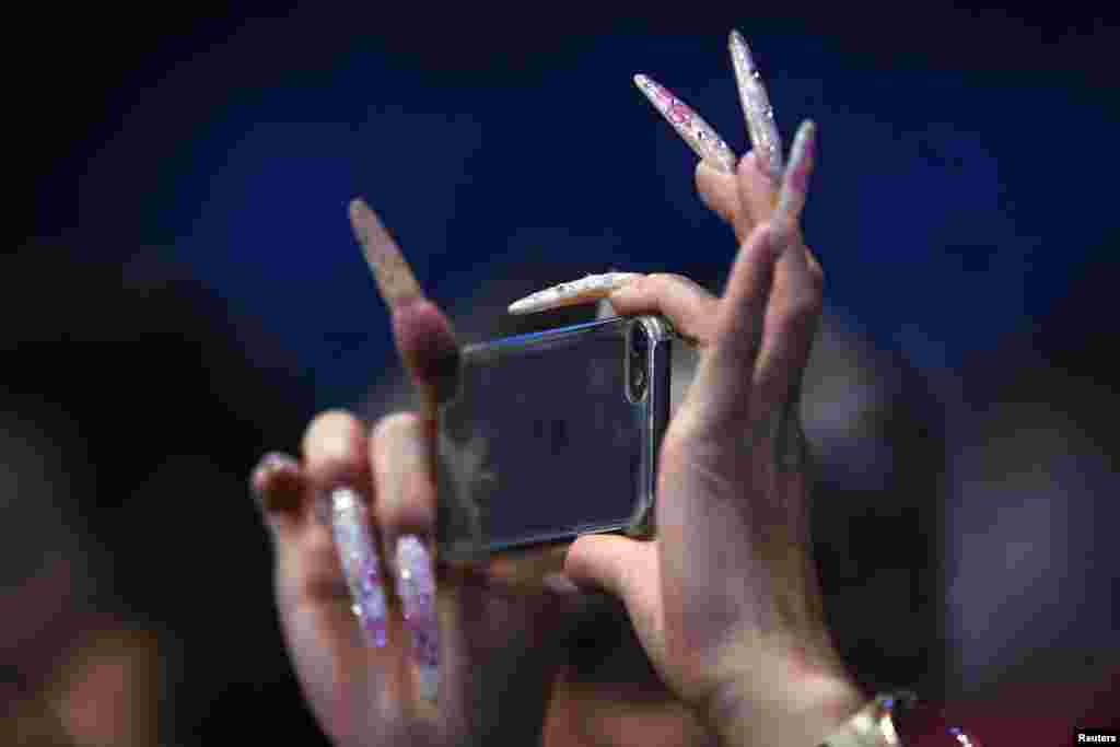 A spectator takes a picture of Barclays ATP World Tour Finals tennis tournament in London.