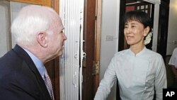 US Senator John McCain, left, bids farewell to Myanmar democracy icon Aung San Suu Kyi at her lakeside home after holding talks, June 2, 2011, Rangoon, Burma.