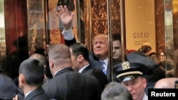 FILE - Republican presidential nominee Donald Trump waves to supporters outside the front door of Trump Tower where he lives in the Manhattan borough of New York, Oct. 8, 2016. 