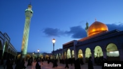 FILE - Shi'ite Muslims mostly from Iraq flock to the shrine of Sayyida Zeinab in Syria, March 25, 2003. Shi'ite Muslims frequent the shrine they believe is the tomb of the Prophet Mohammed's granddaughter. 