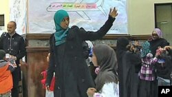 Hafsa Abdelrahman leads the children of the Dar Al-Hijrah weekend school in Falls Church, Virginia, into a mock-up of the Muslim holy city Mecca, October 2011.