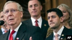 FILE - Senate Majority Leader Mitch McConnell speaks on Capitol Hill in Washington. House Speaker Paul Ryan stands behind him to the right.