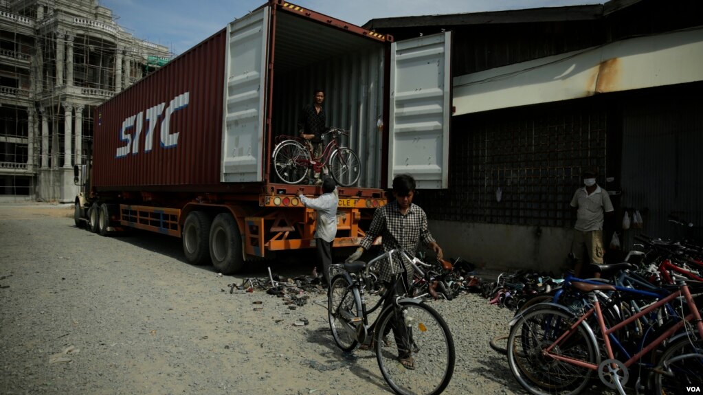 A small team helps to unload, wash, and repair 400 bikes from any damages caused in transit. (Kiana Duncan/VOA Khmer)
