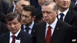 FILE - Turkey's President Recep Tayyip Erdogan (R) and Prime Minister Ahmet Davutoglu (L) arrive to attend funeral prayers for army officer Seckin Cil, who was killed in Sur, Diyarbakir, in Ankara, Turkey, Feb. 18, 2016. 