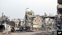 A handout picture made available by the General Committee of the Syrian Revolution shows destroyed buildings in Inshaat district of Homs, March 7, 2012