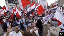 Iraqis chant slogans during a demonstration in solidarity with Bahraini protesters in Baghdad, April 23, 2011