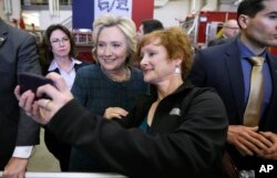 Democratic presidential candidate Hillary Clinton poses for a photo with Cynthia Johnson of Osage, Iowa, during a campaign stop at the Osage Public Safety Center, Jan. 5, 2016, in Osage, Iowa.