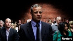 Oscar Pistorius awaits start of court proceedings while his brother looks on, Feb. 19, 2013.