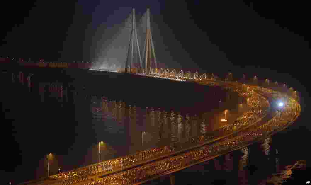 Runners compete along the Bandra-Worli sea link over the Arabian Sea during the Mumbai Marathon in Mumbai, India.