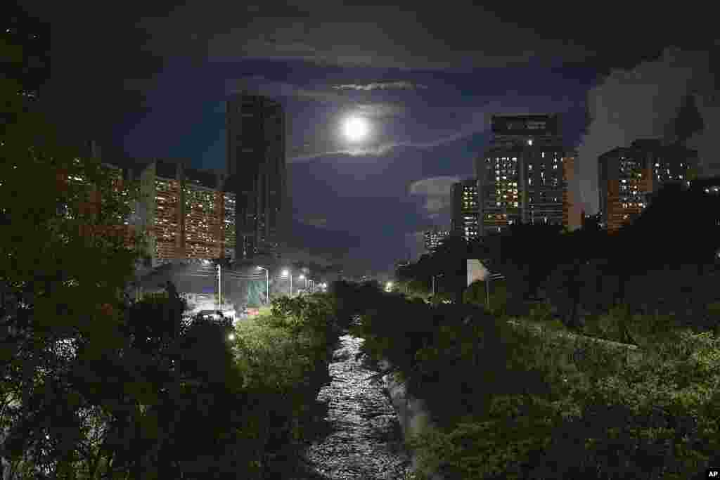 The El Guaire River is illuminated by a full moon in Caracas, Venezuela, Oct. 31, 2020, amid the coronavirus pandemic lockdown.