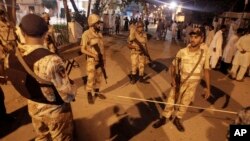 Pakistani security personnel cordon off the area of blasts in Karachi, Pakistan on, May 4, 2013.