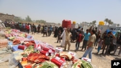 Displaced civilians from Ramadi wait to receive humanitarian aid from the United Nations in a camp in the town of Amiriyat al-Fallujah, west of Baghdad, Iraq, May 22, 2015. 