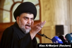 Necef'te cuma namazı sırasında halkı bugünkü gösterilere katılmaya çağıran Iraklı Şii lider Mukteda el Sadr