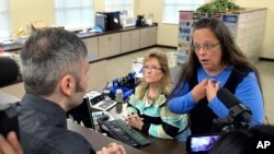 Rowan County Clerk Kim Davis, right, talks with David Moore following her office's refusal to issue marriage licenses at the Rowan County Courthouse in Morehead, Ky., Sept. 1, 2015.