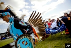 Friends and family members of Ashley HeavyRunner Loring hold a traditional blanket dance before the crowd at the North American Indian Days celebration to raise awareness and funds for her search on the Blackfeet Indian Reservation in Browning, Mont., July 14, 2018. In January, the FBI took over the case after a tip led investigators off the reservation and into another state.