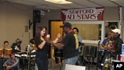 Members of Septo Tipico Tivoli teach students Cuban dances.