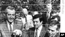 Hungarian Foreign Minister Gyula Horn (r) with Austrian counterpart Alois Mock cut through barbed wire of former Iron Curtain marking border between East, West in Sopron, Hungary, 27 Jun 1989