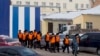 FILE - Inmates are being escorted to perform work at a penal colony in Krasnoyarsk, Russia, Dec. 20, 2013. Beginning with 2017, the Russian correctional system will introduce forced labor as an alternative to traditional prison sentences.