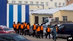 FILE - Inmates are being escorted to perform work at a penal colony in Krasnoyarsk, Russia, Dec. 20, 2013. Beginning with 2017, the Russian correctional system will introduce forced labor as an alternative to traditional prison sentences.