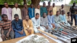A group of men identified by Nigerian police as Boko Haram extremist fighters and leaders are shown to the media, in Maiduguri, Nigeria, July 18, 2018.