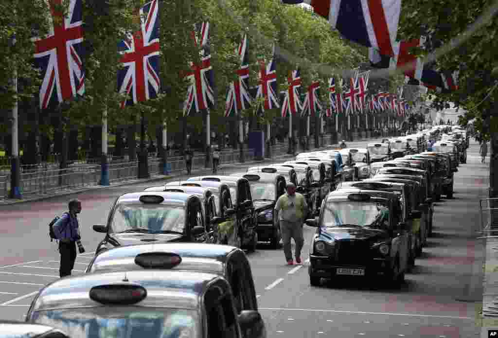 Traditional London black cabs line up along The Mall as taxi drivers block the street to protest over new technology they say endangers passengers, in London. The strike action by taxi drivers hit many European cities sparked by fears about the growing upheaval in the travel and transport industry, largely due to digital technologies.