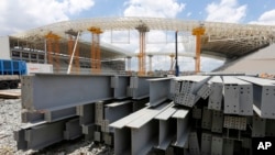 FILE - Steel beams sit outside the Arena de Sao Paulo in Sao Paulo, Brazil, Dec. 8, 2013. 