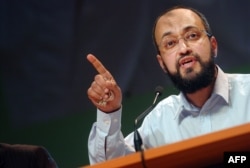 FILE - Hani Ramadan delivers a speech during the annual meeting of muslims in France, 14 Apr. 2007 in Le Bourget, north of Paris.