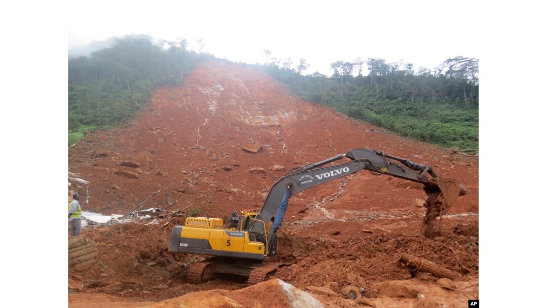 Heavy equipment is used as rescue workers search for survivors and victims following a mudslide in Regent, east of Freetown, Sierra Leone, Aug. 14, 2017.