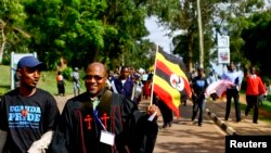 Anti-gay Pastor Martin Ssempa carries national flag while leading procession for Uganda's anti-gay bill, Kampala, March 31, 2014.