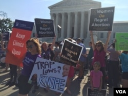 Pro-life and pro-choice demonstrators wave signs and make their voices heard after the Supreme Court upheld abortion rights in a 5-3 decision, in front of the Supreme Court building in Washington, June 27, 2016. (J. Oni / VOA News)