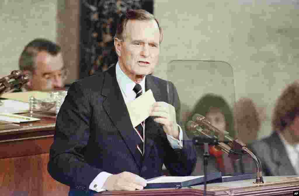 U.S. President George H. Bush removes a letter from his pocket during his first State of the Union address, Jan. 31, 1990.