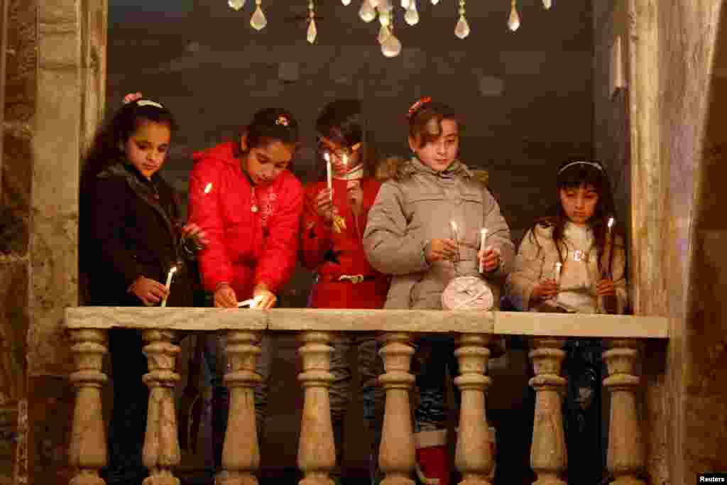 Iraqi Christians attend a Mass on Christmas at an Orthodox church in the town of Bashiqa, east of Mosul, Dec. 25, 2016.