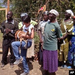 B1G1 founder, Masami Sato (C) holds a goat donated through her company at the World Youth International Mama Ann Odede Complex in western Kenya (File)