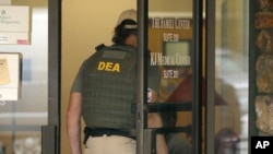 FILE - A Drug Enforcement Administration officer walks into a medical clinic in Little Rock, Arkansas, May 20, 2015.