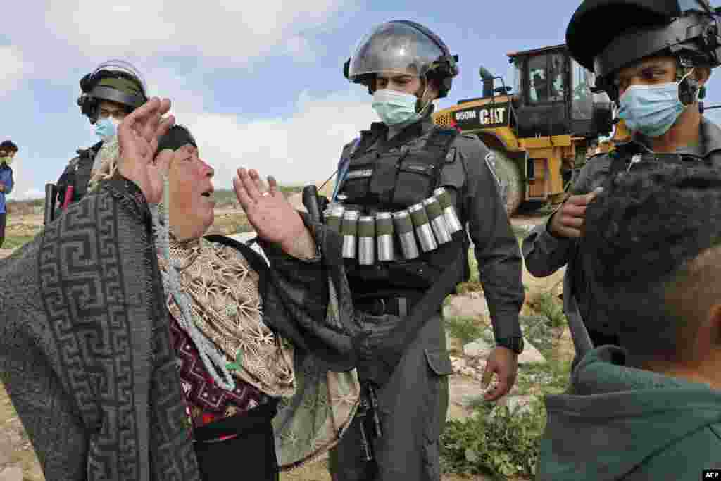 Palestinians react as Israeli authorities prepare to demolish a house located in the area C where Israel retains control, including over planning and construction in a village south of Yatta in the southern area of the West Bank town of Hebron.