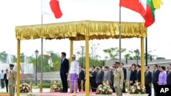 Japanese Prime Minister Shinzo Abe and Burma's President Thein Sein, take a salute of the honor guard at Presidential Palace in Naypyitaw, Burma, May 26, 2013. 