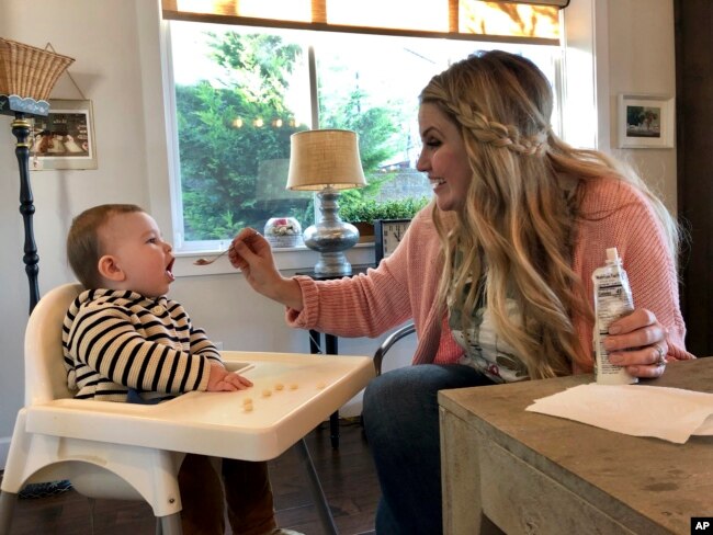 Jocelyn Smith cares for her 11-month-old son, Mason at their home in Camas, Wash., Jan. 30, 2019. Smith has been afraid to take Mason out of the house during a measles outbreak in southwest Washington because he is too young to receive the measles vaccine