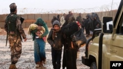 FILE - Syrian refugees are seen at Rukban camp, located in a no-man's-land on the border between Syria and Jordan, March 1, 2017