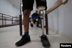 Palestinian Abdallah Qassem, 17, who, according to medics, lost both legs after he was shot by Israeli forces during a protest at the Israel-Gaza border, is seen inside an artificial limb center in Gaza City, April 2, 2019.