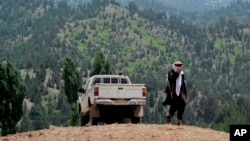 FILE - A Taliban militant is seen walking in Pakistan's tribal region of North Waziristan. Aug. 12, 2013. 