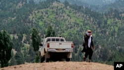 FILE - A Taliban militant is seen walking in Pakistan's tribal region of North Waziristan, Aug. 12, 2013.