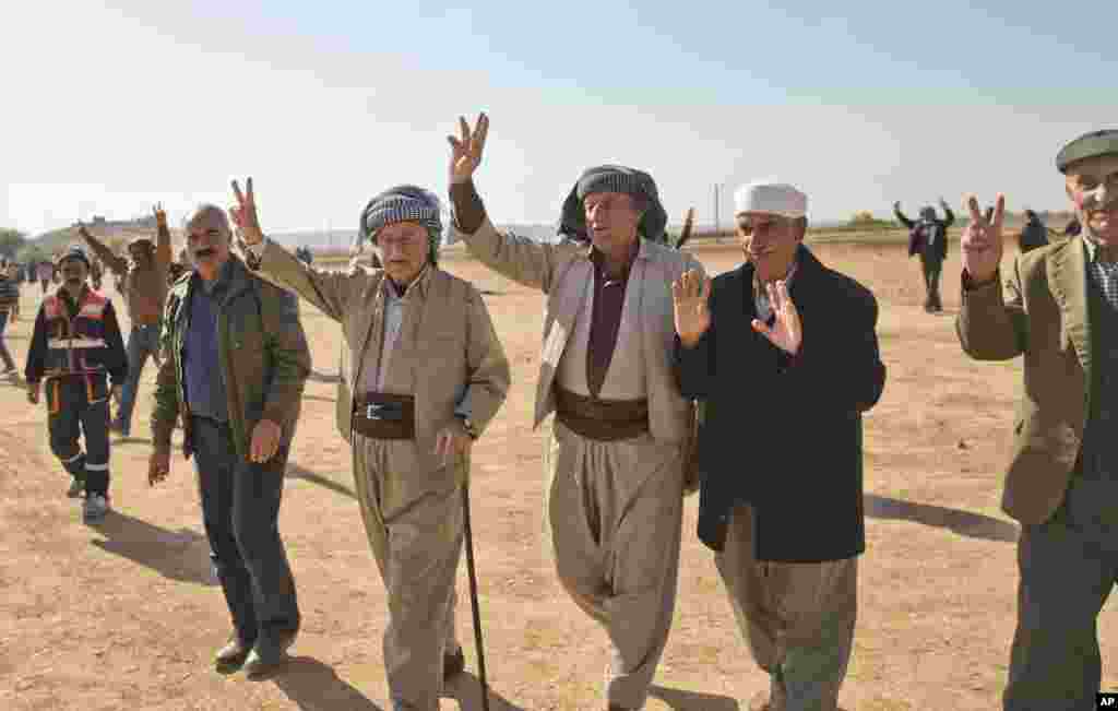 Kurds show victory signs after a solidarity rally with the Syrian city of Kobani in the village of Caykara, Turkey, Nov. 11, 2014.